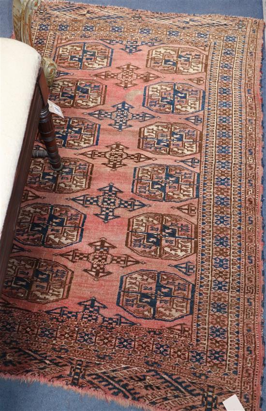 A Bokhara peach ground rug and three Turkish geometric rugs, largest 200 x 100cm.